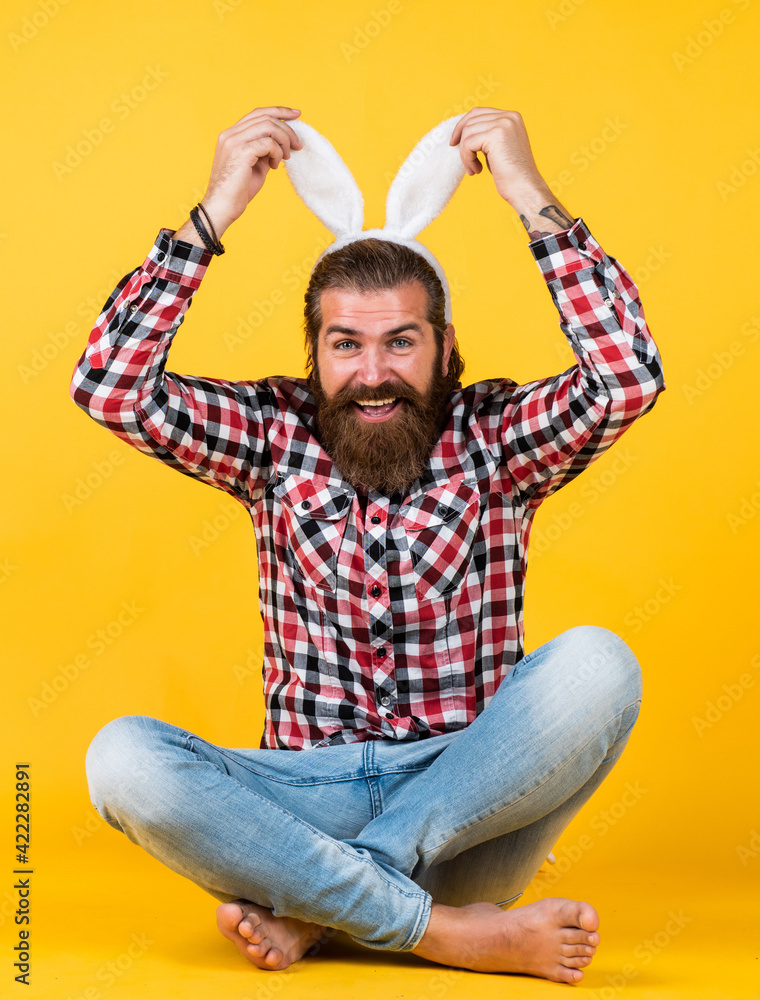 Caucasian mature hipster in buny ears with trendy hairstyle in checkered shirt celebrate easter, easter fun Caucasian mature hipster in buny ears with trendy hairstyle in checkered shirt celebrate easter, easter fun