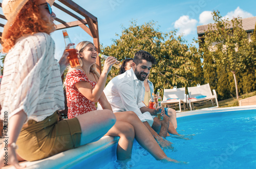 Group of friends having fun at summer vacation enjoying at poolside party. © Zoran Zeremski