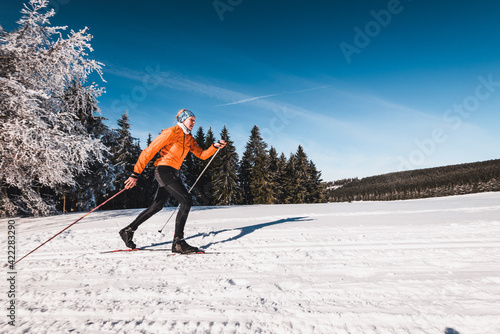 Langläufer in wunderschöner sonniger Winterlandschaft beim Skifahren klassische Technik