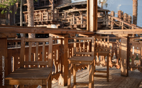Wooden chairs on the summer terrace close up.