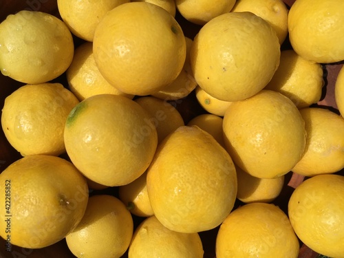 Many ripe yellow lemons in a market