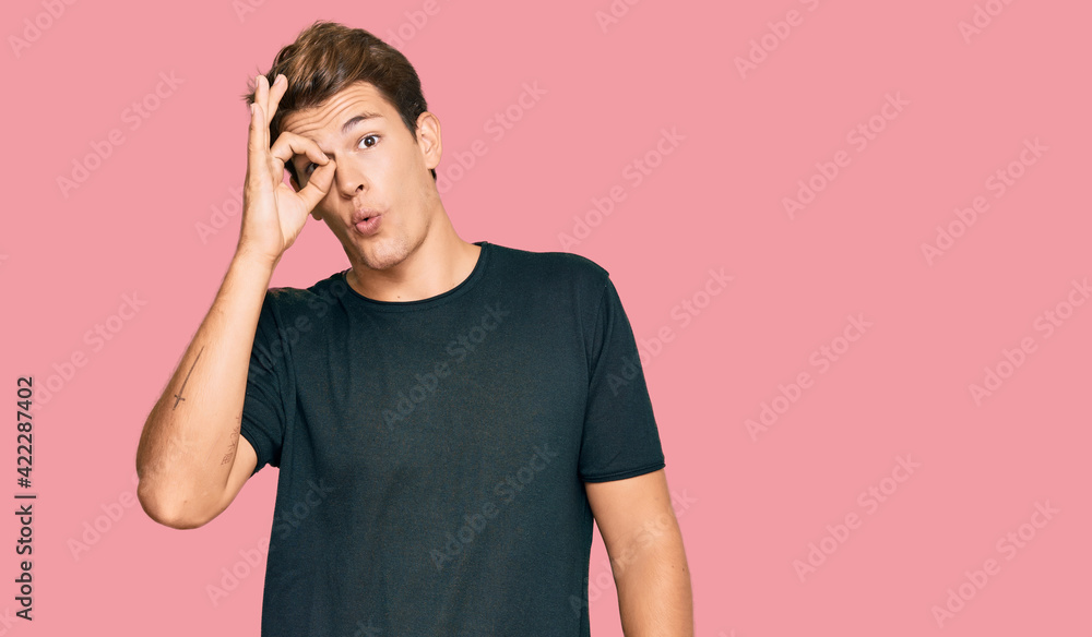 Handsome caucasian man wearing casual clothes doing ok gesture shocked with surprised face, eye looking through fingers. unbelieving expression. Handsome caucasian man wearing casual clothes doing ok gesture shocked with surprised face, eye looking through fingers. unbelieving expression.
