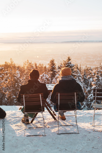 Photography Person enjoying view over trees and mountains in the winter