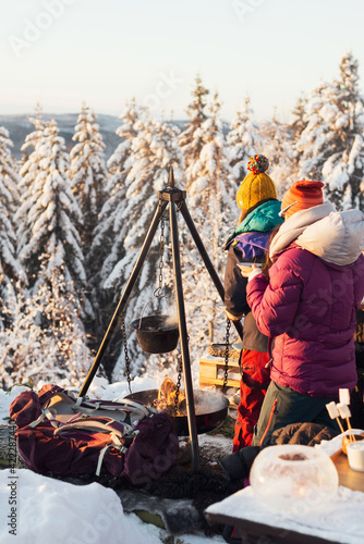 Cooking a meal on a bonfire. Camping on a winter day in Oslo, Norway.