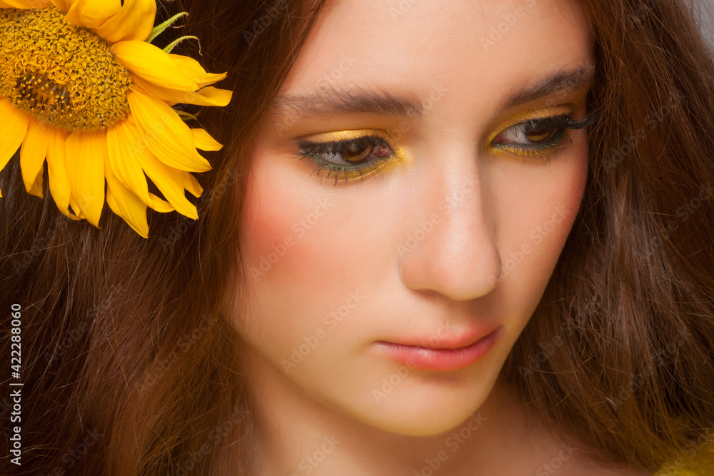 Woman with stylish colorful makeup and sunflowers Woman with stylish colorful makeup and sunflowers