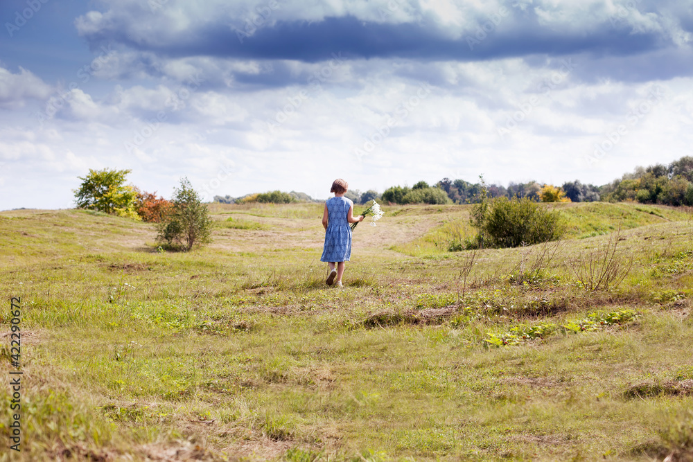 Russian girl  with bouquet of daisies in   summer meadow