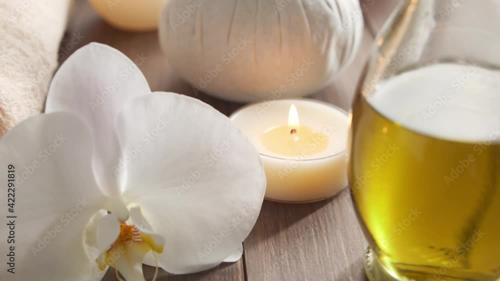 Spa background. Towel, candles, flowers, massaging stones and herbal balls. Massage, oriental therapy, wellbeing and meditation. Spa background. Towel, candles, flowers, massaging stones and herbal balls. Massage, oriental therapy, wellbeing and meditation.