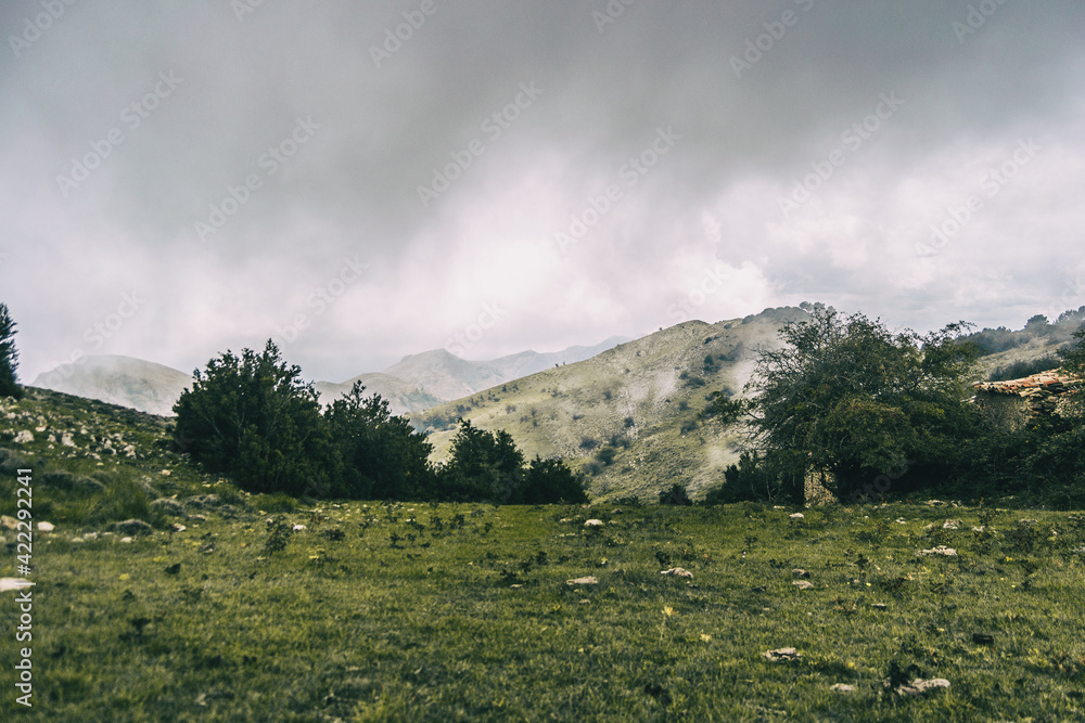 cloudy day with fog in the mountains of the natural park of the ports, in tarragona (spain)