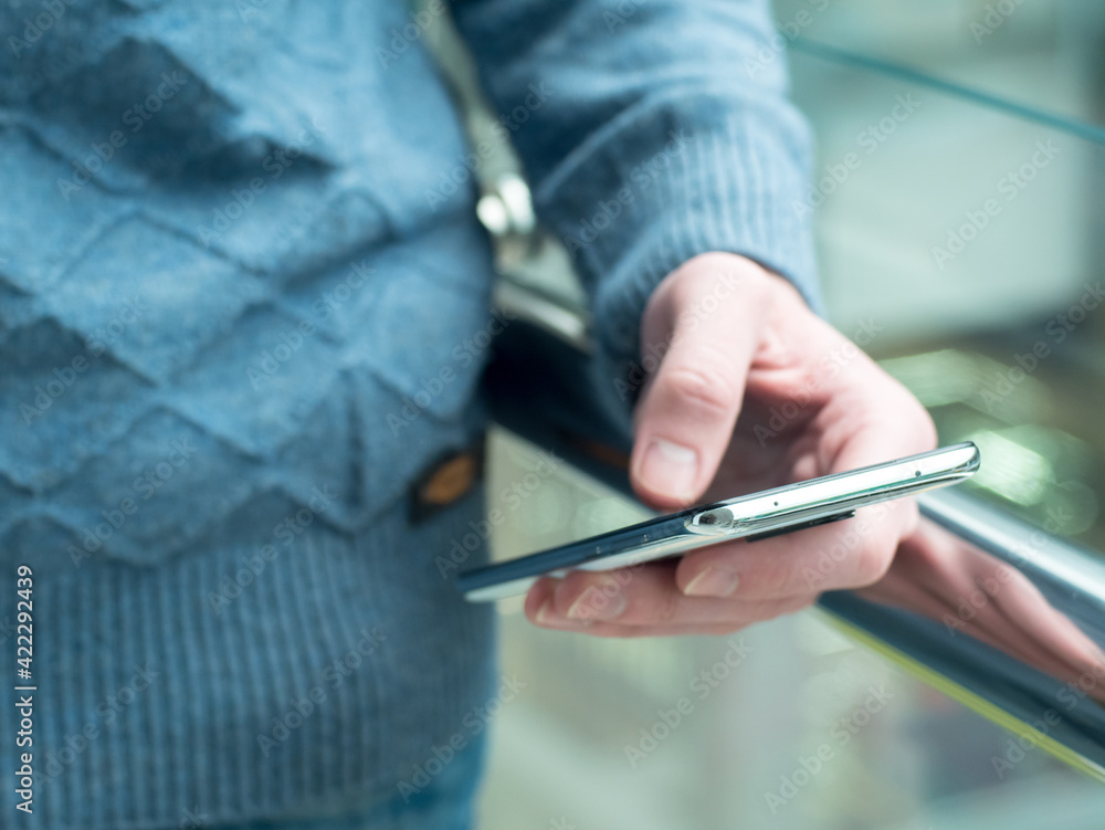 Fototapeta premium Man using smartphone. Close up of hand dolding phone.