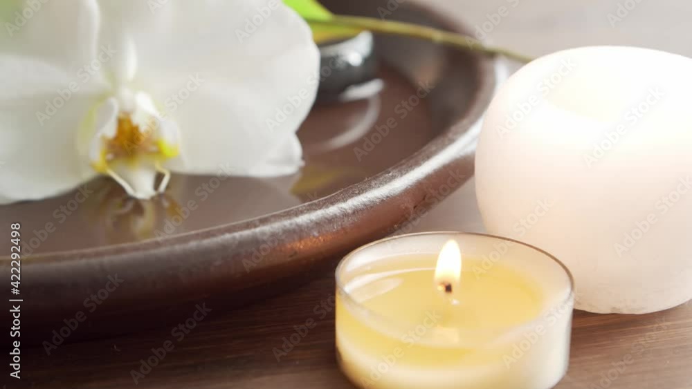 Spa background. Towel, candles, flowers, massaging stones and herbal balls. Massage, oriental therapy, wellbeing and meditation. Spa background. Towel, candles, flowers, massaging stones and herbal balls. Massage, oriental therapy, wellbeing and meditation.