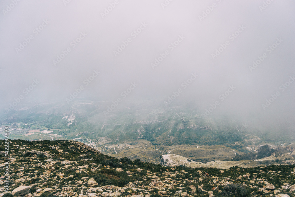 cloudy day with fog in the mountains of the natural park of the ports, in tarragona (spain)