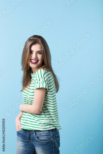 Natural laughing girl on a blue background.