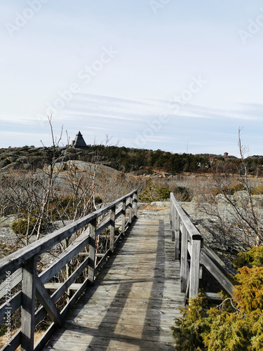 Vertical shot of a wooden bridge in a landscape in Stavern, Norway photo