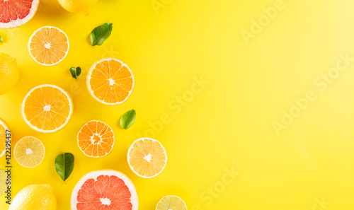 Summer composition made from oranges, lemon or lime on pastel yellow background. Fruit minimal concept. Flat lay, top view, copy space.