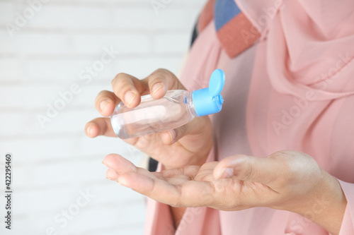  young women using hand sanitizer with copy space 