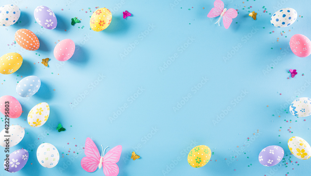 Happy easter! Colourful of Easter eggs on pastel blue background. Greetings and presents for Easter Day celebrate time. Flat lay ,top view. Happy easter! Colourful of Easter eggs on pastel blue background. Greetings and presents for Easter Day celebrate time. Flat lay ,top view.