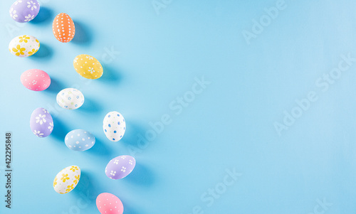 Happy easter! Colourful of Easter eggs on pastel blue background. Greetings and presents for Easter Day celebrate time. Flat lay ,top view.