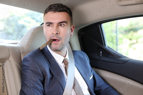Cuban businessman smoking a cigar in limousine  © ajr_images