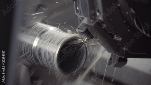 Turning lathe in action. Facing operation of metal blank on turning machine with cutting tool. Old turning lathe machine in turning workshop. Machining high precision mold part by cnc