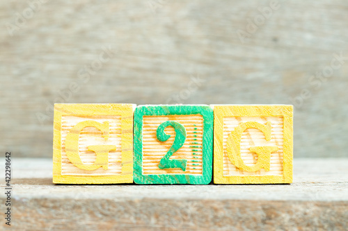 Color alphabet letter block in word G2G (abbreviation of Government to government) on wood background photo