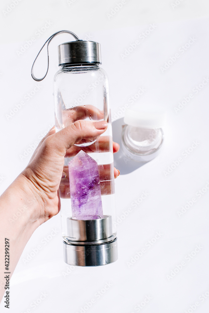 Crystal quartz bottle for a mockup and add your own logo, Re-usable water bottles with gemstone crystals sparkling at their core Crystal quartz bottle for a mockup and add your own logo, Re-usable water bottles with gemstone crystals sparkling at their core