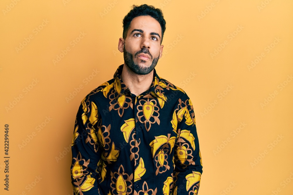Young hispanic man wearing casual shirt making fish face with lips, crazy and comical gesture. funny expression. Young hispanic man wearing casual shirt making fish face with lips, crazy and comical gesture. funny expression.