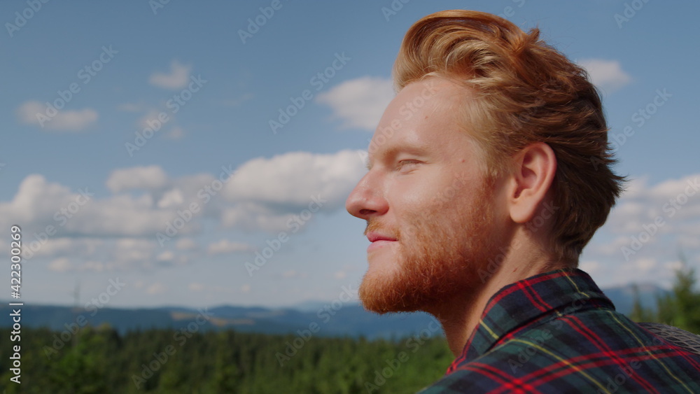 Guy enjoying mountain landscape at summer. Male traveler looking green woods Guy enjoying mountain landscape at summer. Male traveler looking green woods