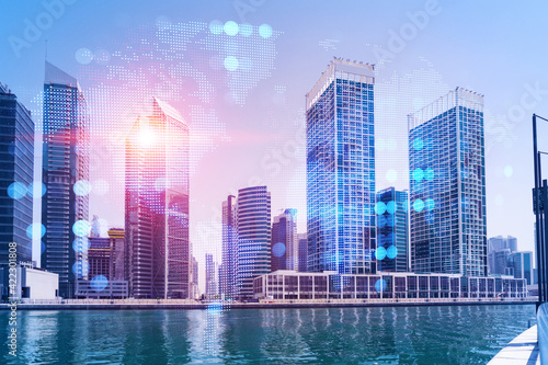 Skyscrapers of Dubai business downtown. International hub of trading and financial services. Social network icons hologram, concept of people connection. Double exposure. Dubai Canal waterfront.