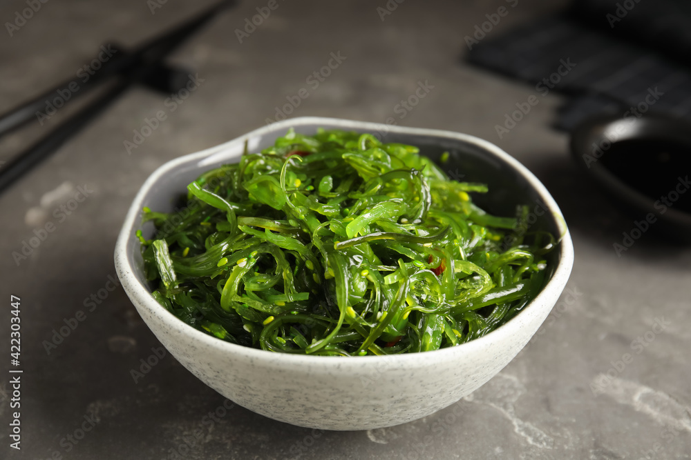 Japanese seaweed salad served on grey table, closeup Japanese seaweed salad served on grey table, closeup