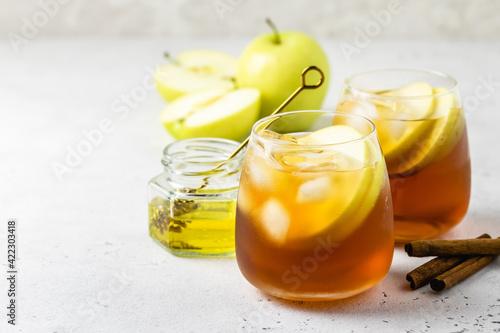 Spiced ginger honey apple iced tea in glasses. Space ofr text. photo