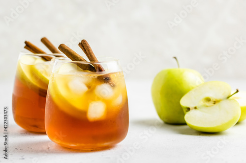 Delicious refreshing summer apple cinnamon iced tea in glasses. Space ofr text.