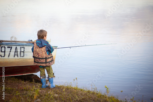 male fisherman on the riverbank with a fishing rod, Selective focus