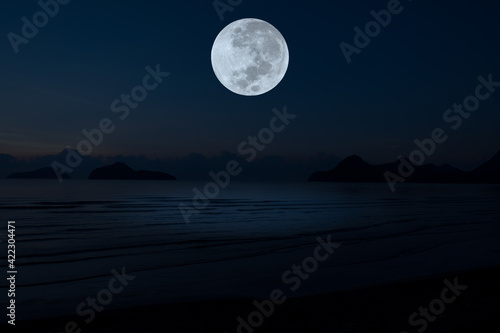 Full moon on sky over sea in the night.