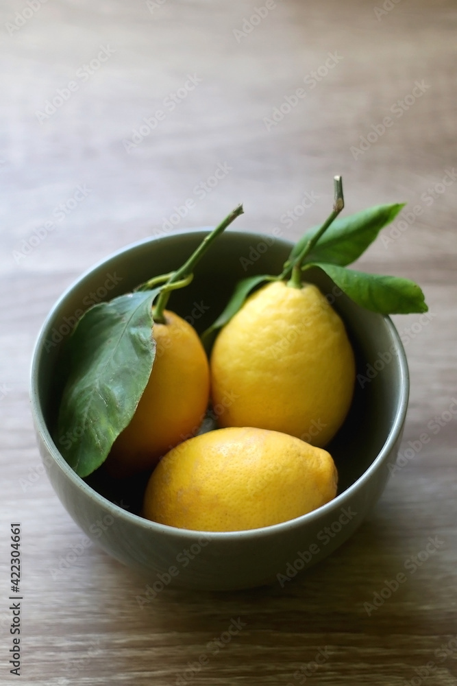 Bowl of lemons on a table. Selective focus.