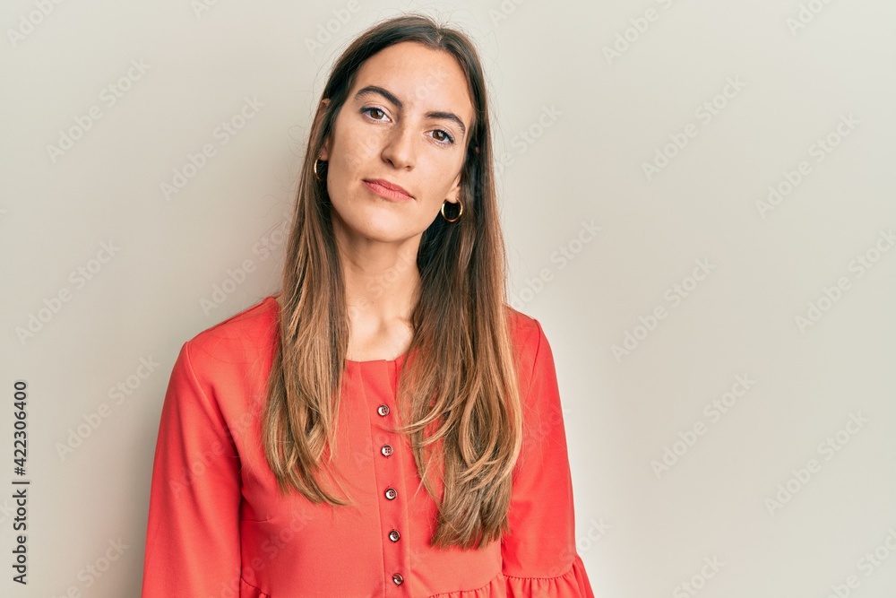 Young beautiful woman wearing casual clothes relaxed with serious expression on face. simple and natural looking at the camera. Young beautiful woman wearing casual clothes relaxed with serious expression on face. simple and natural looking at the camera.