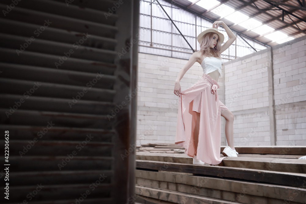 Asian blonde model in fashion shoot in a workshop Asian blonde model in fashion shoot in a workshop