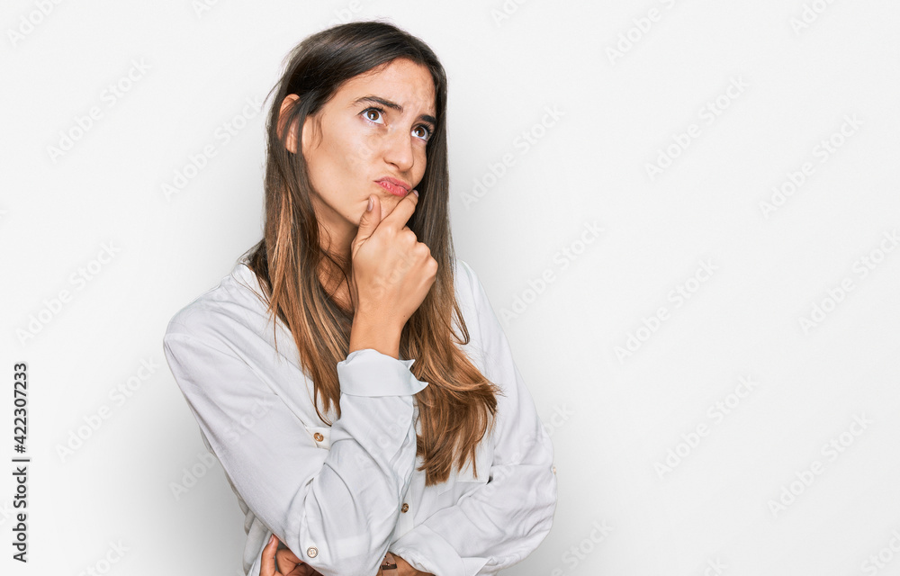 Young beautiful woman wearing casual clothes thinking worried about a question, concerned and nervous with hand on chin Young beautiful woman wearing casual clothes thinking worried about a question, concerned and nervous with hand on chin