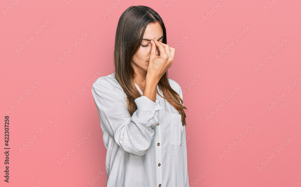 Young beautiful woman wearing casual clothes tired rubbing nose and eyes feeling fatigue and headache. stress and frustration concept. Young beautiful woman wearing casual clothes tired rubbing nose and eyes feeling fatigue and headache. stress and frustration concept.