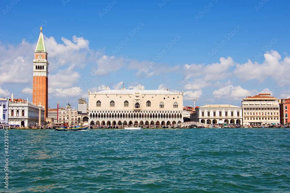 The historical Doge's palace and Campanile of Saint Mark's Cathedral on Piazza di San Marco, view from the the Grand Canale in Venice, Italy. Italian buildings cityscape. Famous romantic city on water