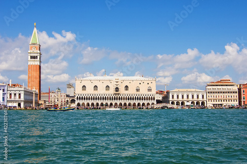 The historical Doge's palace and Campanile of Saint Mark's Cathedral on Piazza di San Marco, view from the the Grand Canale in Venice, Italy. Italian buildings cityscape. Famous romantic city on water © Blumesser