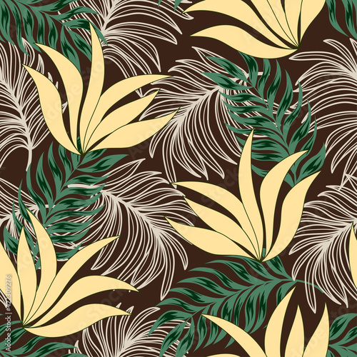 Bright tropical seamless pattern with trendy tropical plants and leaves on a brown background. Summer colorful hawaiian seamless pattern with tropical plants. Beautiful seamless vector floral pattern.
