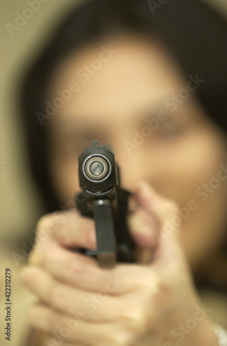 The woman holds a gun to shoot  photo