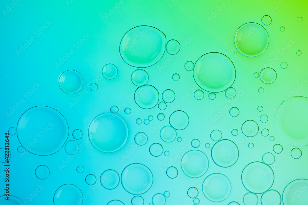 Vivid neon background with bubbles. Colorful abstract backdrop with bright gradients on blobs. Blue, turquoise and green white overflowing colors.