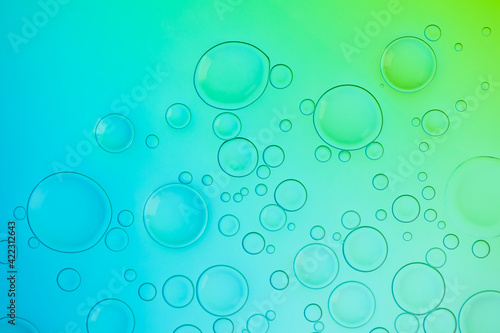 Vivid neon background with bubbles. Colorful abstract backdrop with bright gradients on blobs. Blue, turquoise and green white overflowing colors.