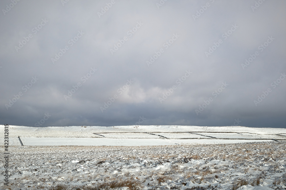 Snowy field below White Edge, Peak District, UK Snowy field below White Edge, Peak District, UK