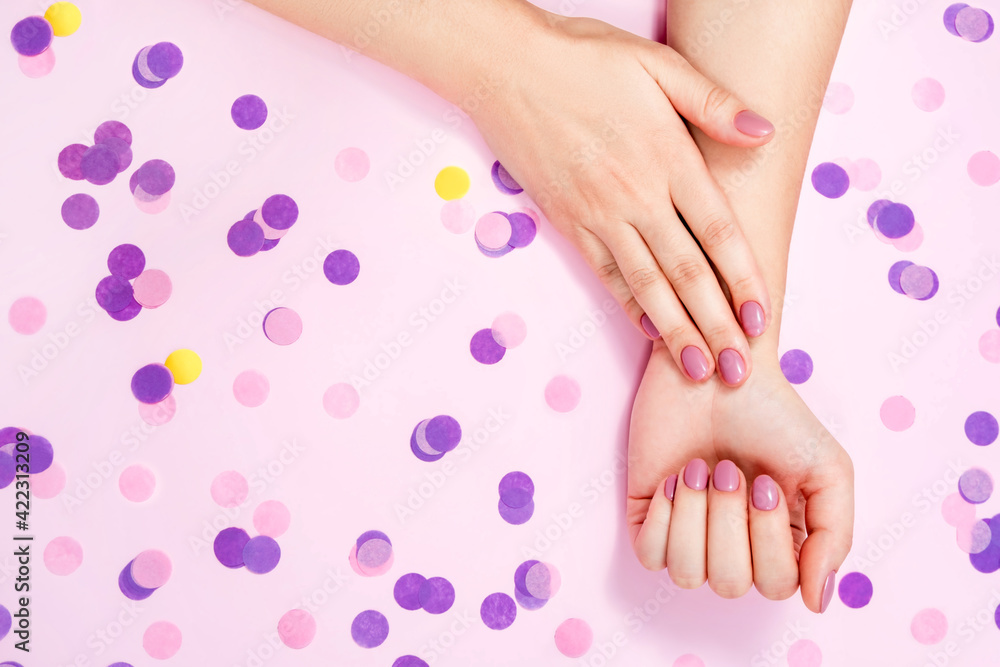 Beautiful female hands on a pink background. Beautiful female hands on a pink background.