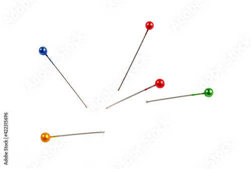 five multi-colored pins on a white background, isolate.