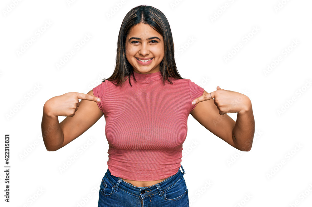 Young hispanic girl wearing casual t shirt looking confident with smile on face, pointing oneself with fingers proud and happy. Young hispanic girl wearing casual t shirt looking confident with smile on face, pointing oneself with fingers proud and happy.