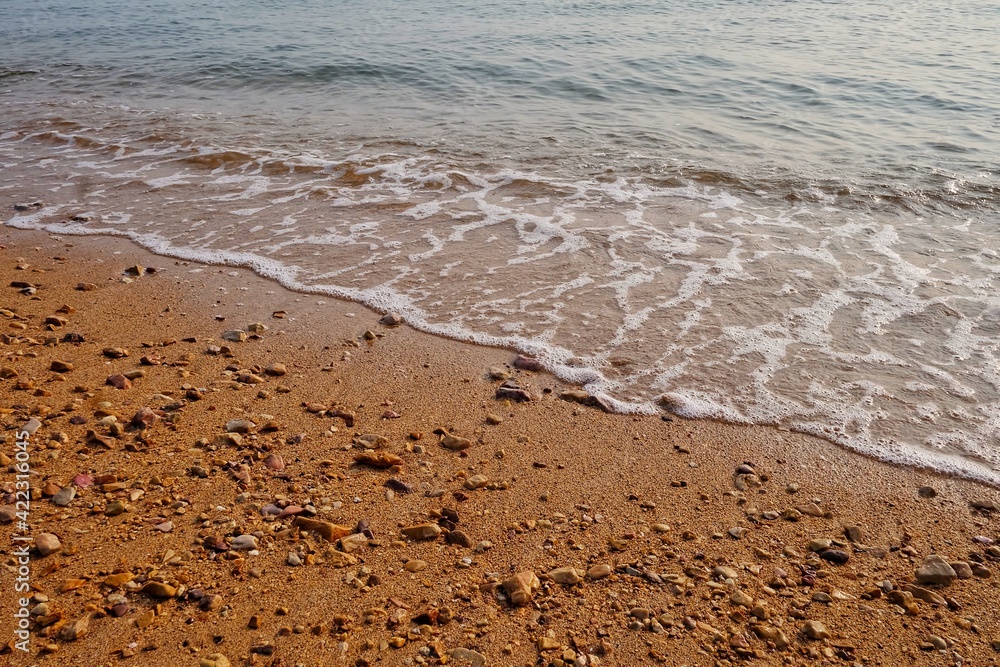 Small waves on the sea beach at the lately evening for backdrop background with red sand Small waves on the sea beach at the lately evening for backdrop background with red sand