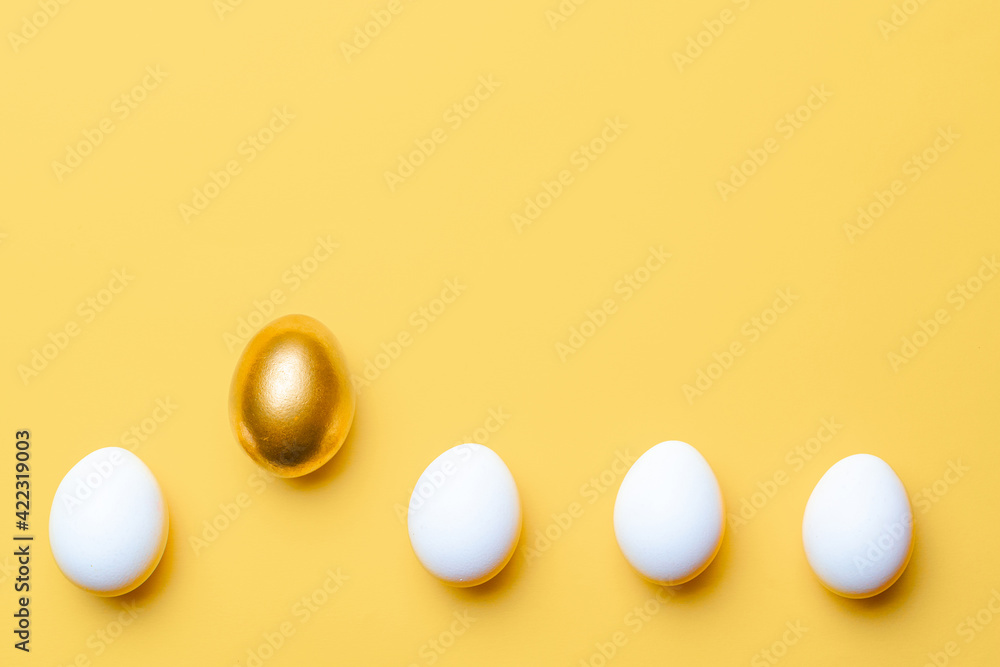 Easter background. Golden, white colour egg on pastel yellow background in Happy Easter decoration. Spring holiday top view concept. Easter background. Golden, white colour egg on pastel yellow background in Happy Easter decoration. Spring holiday top view concept.